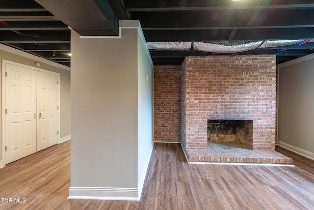 1236 Nassau Dr, Kingsport, TN 37660 - unfurnished living room featuring baseboards, wood finished floors, and a brick fireplace