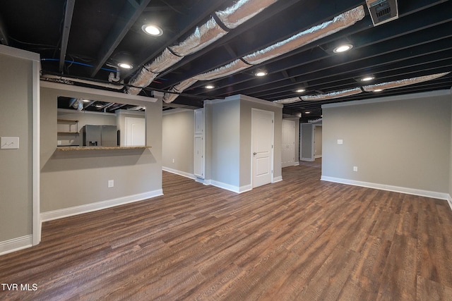 1236 Nassau Dr, Kingsport, TN 37660 - finished basement with stainless steel refrigerator with ice dispenser, wood finished floors, and baseboards