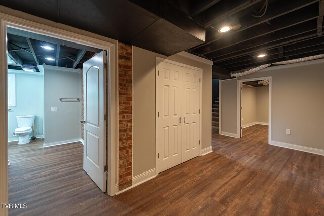 1236 Nassau Dr, Kingsport, TN 37660 - finished below grade area featuring dark wood-style flooring, baseboards, and brick wall