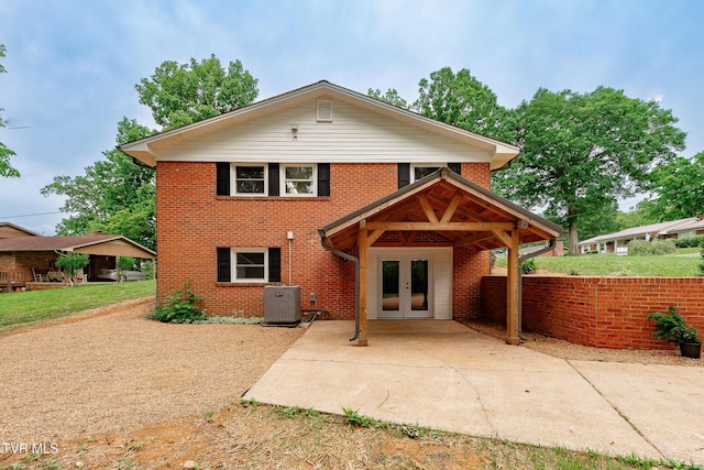 1236 Nassau Dr, Kingsport, TN 37660 - back of house featuring french doors, central air condition unit, brick siding, and a patio