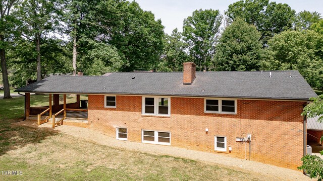 1236 Nassau Dr, Kingsport, TN 37660 - rear view of property with a chimney, view of wooded area, and a lawn