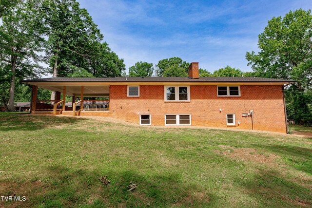 1236 Nassau Dr, Kingsport, TN 37660 - rear view of house with a chimney, a yard, and brick siding