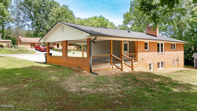 1236 Nassau Dr, Kingsport, TN 37660 - back of house with a chimney, brick siding, and a lawn