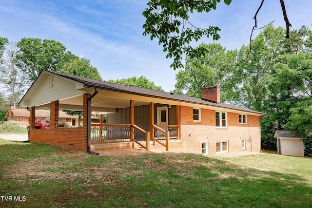 1236 Nassau Dr, Kingsport, TN 37660 - rear view of property featuring a chimney, a yard, brick siding, and an outdoor structure