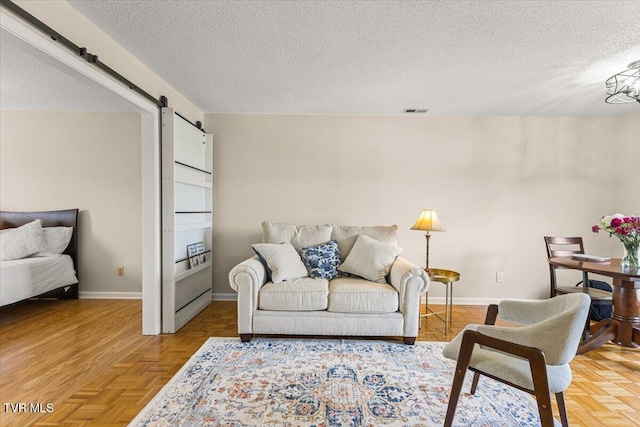 2700 Indian Ridge Rd Unit 12, Johnson City, TN 37604 - living room featuring a barn door, a textured ceiling, and baseboards