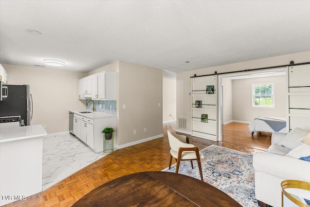 2700 Indian Ridge Rd Unit 12, Johnson City, TN 37604 - living area featuring a barn door, baseboards, and a textured ceiling