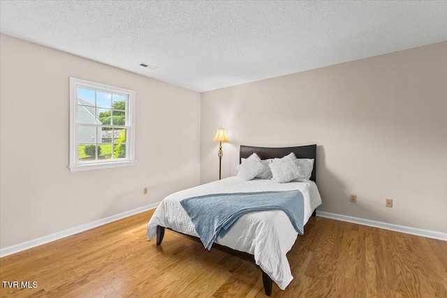 2700 Indian Ridge Rd Unit 12, Johnson City, TN 37604 - bedroom featuring wood finished floors, baseboards, and a textured ceiling