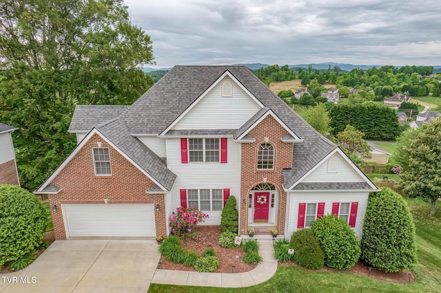 220 Michaels Ridge Blvd, Johnson City, TN 37615 - traditional home with roof with shingles, driveway, brick siding, and an attached garage