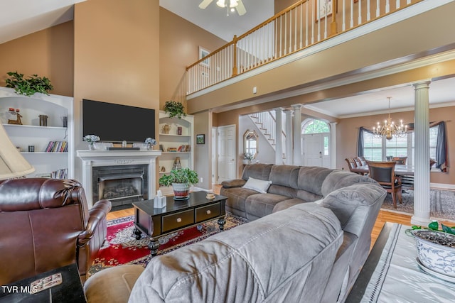 220 Michaels Ridge Blvd, Johnson City, TN 37615 - living area featuring wood finished floors, decorative columns, stairway, a chandelier, and a towering ceiling