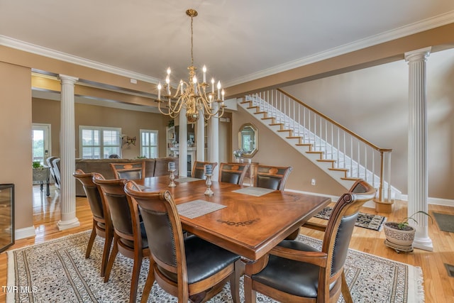 220 Michaels Ridge Blvd, Johnson City, TN 37615 - dining room featuring ornate columns, light wood finished floors, ornamental molding, baseboards, and a chandelier