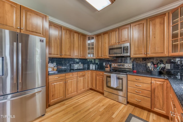 220 Michaels Ridge Blvd, Johnson City, TN 37615 - kitchen featuring appliances with stainless steel finishes, light wood-style flooring, backsplash, brown cabinetry, and crown molding