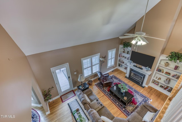 220 Michaels Ridge Blvd, Johnson City, TN 37615 - living area with high vaulted ceiling, wood finished floors, ceiling fan, a fireplace with flush hearth, and baseboards