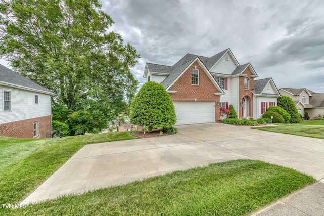 220 Michaels Ridge Blvd, Johnson City, TN 37615 - traditional home featuring driveway, brick siding, an attached garage, and a front yard