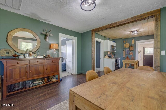 3901 Rocky Hill Ln, Kingsport, TN 37660 - dining room featuring dark wood-style floors, a textured ceiling, and baseboards
