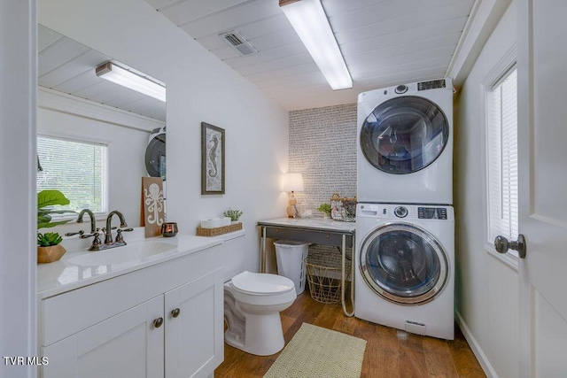 3901 Rocky Hill Ln, Kingsport, TN 37660 - bathroom featuring stacked washer / dryer, vanity, toilet, and plenty of natural light