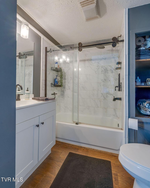 3901 Rocky Hill Ln, Kingsport, TN 37660 - bathroom with combined bath / shower with glass door, vanity, toilet, a textured ceiling, and wood finished floors