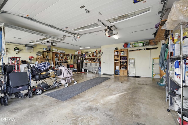 5009 Surrey Dr, Kingsport, TN 37664 - garage featuring a garage door opener and a workshop area