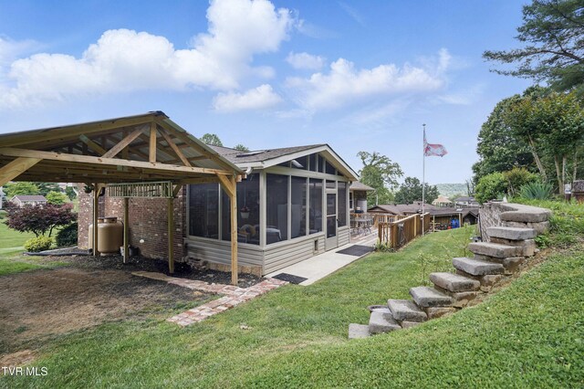 5009 Surrey Dr, Kingsport, TN 37664 - back of house featuring a sunroom, a lawn, and a carport