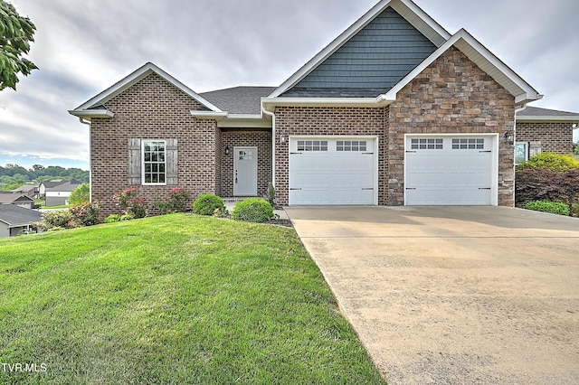 1030 Savin Fls, Gray, TN 37615 - view of front facade featuring a garage, a front lawn, driveway, stone siding, and brick siding