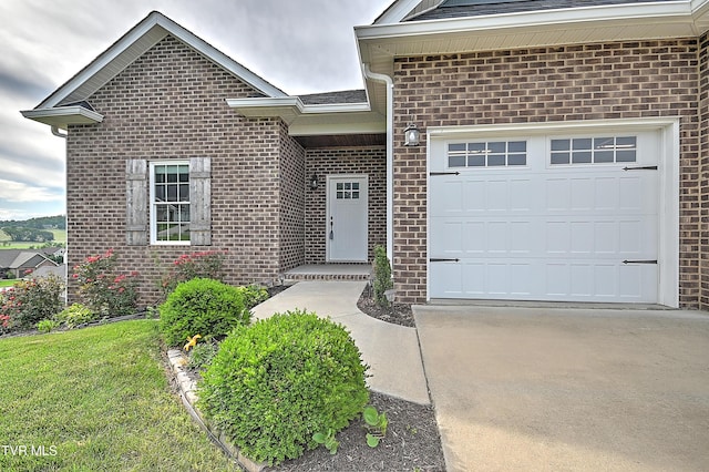 1030 Savin Fls, Gray, TN 37615 - property entrance featuring brick siding, driveway, a garage, and a lawn