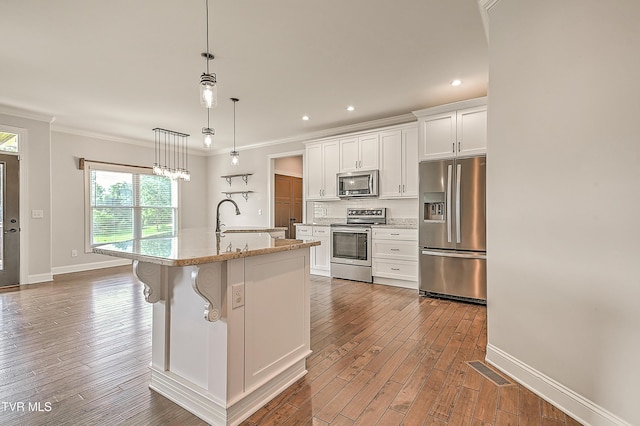 1030 Savin Fls, Gray, TN 37615 - kitchen with stainless steel appliances, ornamental molding, wood finished floors, white cabinetry, and a kitchen island with sink