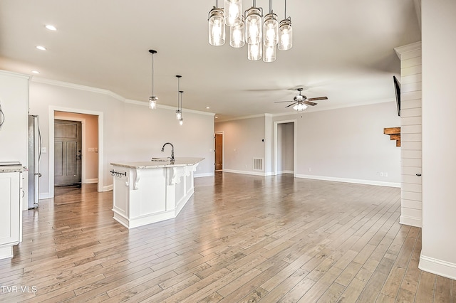 1030 Savin Fls, Gray, TN 37615 - kitchen with ceiling fan, ornamental molding, baseboards, white cabinets, and light wood-style flooring
