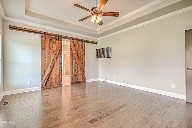 1030 Savin Fls, Gray, TN 37615 - unfurnished room with a barn door, a raised ceiling, a ceiling fan, dark wood finished floors, and crown molding