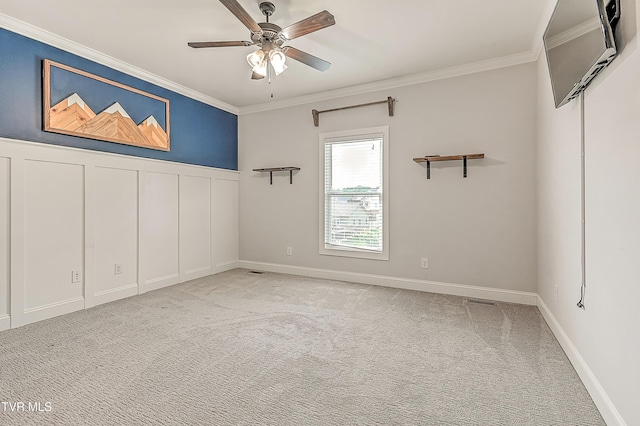 1030 Savin Fls, Gray, TN 37615 - empty room featuring crown molding, carpet, a ceiling fan, a decorative wall, and wainscoting