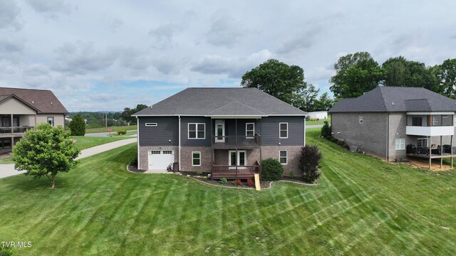 1030 Savin Fls, Gray, TN 37615 - back of property with a lawn, brick siding, and an attached garage