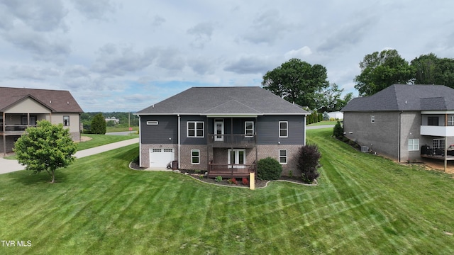 1030 Savin Fls, Gray, TN 37615 - rear view of house with brick siding, a lawn, a balcony, and a garage