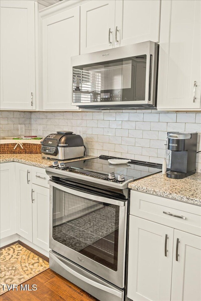 3321 Cottage Green Ct, Kingsport, TN 37664 - kitchen featuring appliances with stainless steel finishes, decorative backsplash, and white cabinets