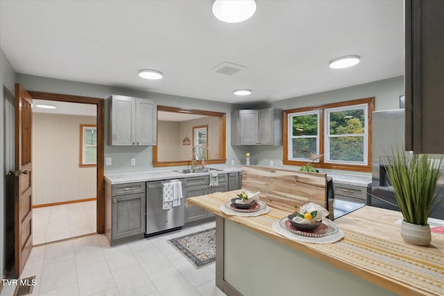 204 Maple Dr, Jonesborough, TN 37659 - kitchen featuring dishwasher, a sink, light countertops, gray cabinets, and light tile patterned floors