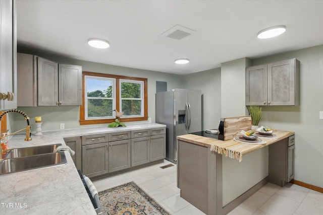 204 Maple Dr, Jonesborough, TN 37659 - kitchen featuring a sink, stainless steel fridge with ice dispenser, butcher block counters, gray cabinets, and light tile patterned flooring