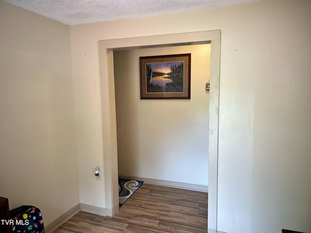 326 Park Ave, Appalachia, VA 24216 - corridor featuring wood finished floors, baseboards, and a textured ceiling