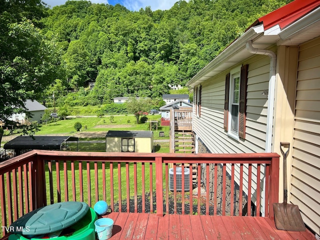 326 Park Ave, Appalachia, VA 24216 - wooden terrace featuring a yard, a view of trees, and central AC unit