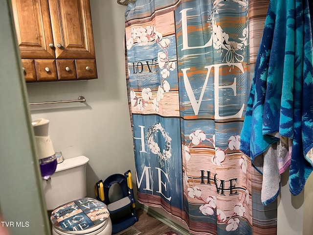 326 Park Ave, Appalachia, VA 24216 - full bathroom with a shower with shower curtain, wood finished floors, and toilet