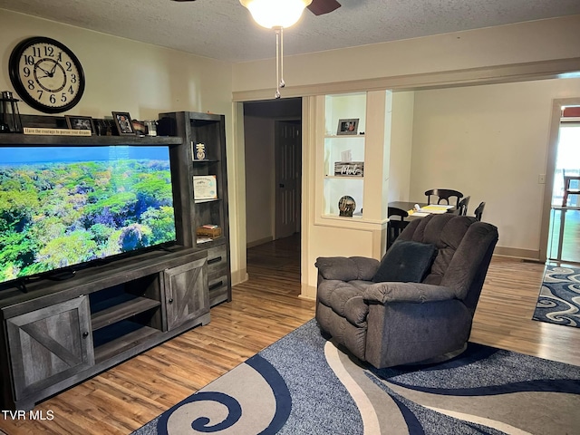 326 Park Ave, Appalachia, VA 24216 - living area featuring a textured ceiling, wood finished floors, a ceiling fan, and baseboards