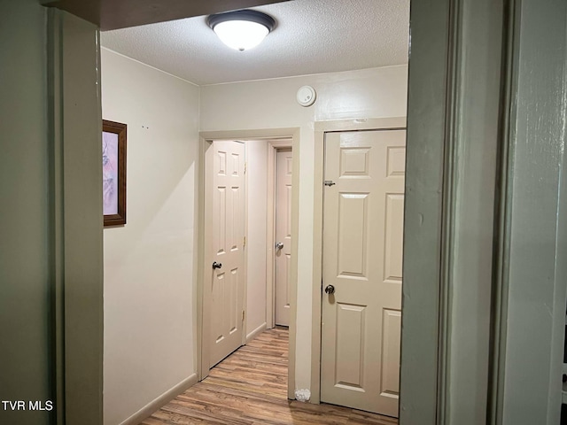 326 Park Ave, Appalachia, VA 24216 - corridor featuring light wood-style flooring and a textured ceiling