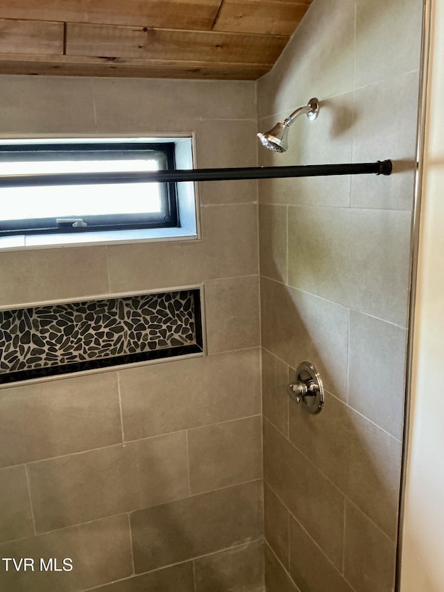 153 Hampton Creek Rd, Roan Mountain, TN 37687 - bathroom featuring tiled shower and wood ceiling