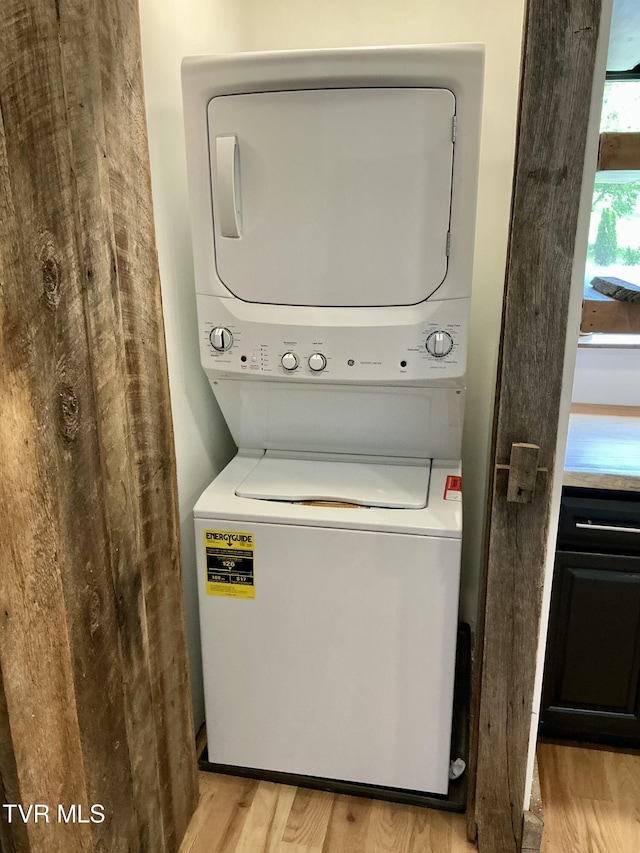 153 Hampton Creek Rd, Roan Mountain, TN 37687 - laundry room with stacked washer and clothes dryer and light wood-style floors