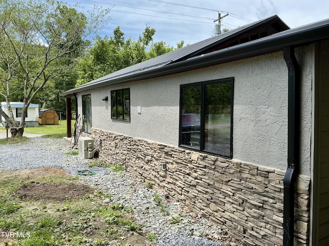 153 Hampton Creek Rd, Roan Mountain, TN 37687 - view of side of property featuring stone siding and stucco siding