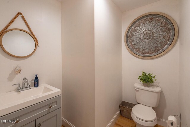 1318 E Lakeview Dr, Johnson City, TN 37601 - half bathroom with vanity, toilet, baseboards, and wood finished floors