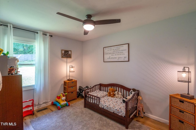1318 E Lakeview Dr, Johnson City, TN 37601 - bedroom with light wood finished floors, multiple windows, a nursery area, and ceiling fan