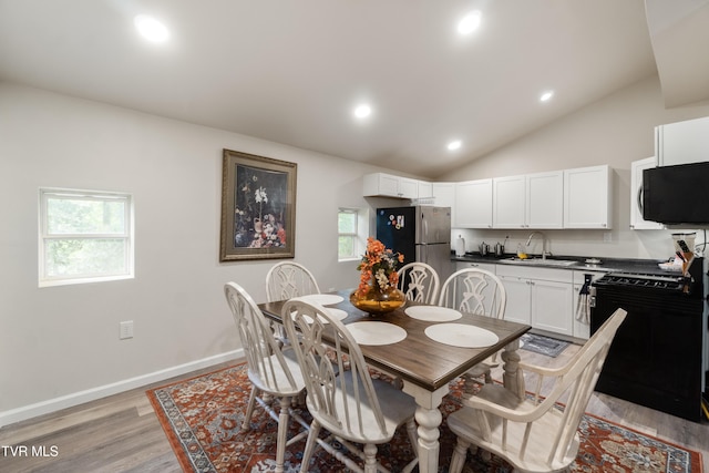 2087 Fodderstack Mountain Loop, Greeneville, TN 37745 - dining area with light wood-type flooring, recessed lighting, vaulted ceiling, and baseboards