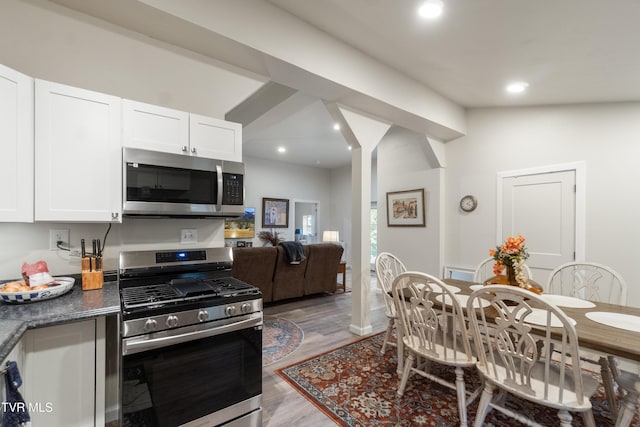 2087 Fodderstack Mountain Loop, Greeneville, TN 37745 - kitchen featuring appliances with stainless steel finishes, white cabinetry, light wood-style floors, dark countertops, and recessed lighting