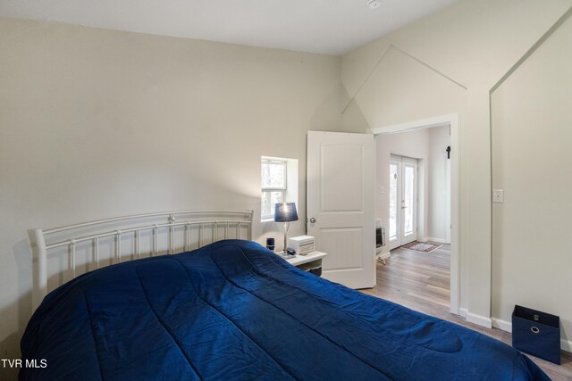 2087 Fodderstack Mountain Loop, Greeneville, TN 37745 - bedroom featuring wood finished floors, lofted ceiling, and baseboards