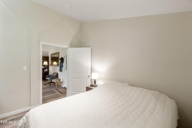2087 Fodderstack Mountain Loop, Greeneville, TN 37745 - bedroom featuring wood finished floors, baseboards, and lofted ceiling