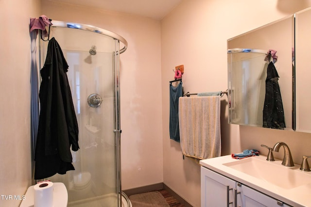 2087 Fodderstack Mountain Loop, Greeneville, TN 37745 - bathroom with a stall shower, vanity, toilet, wood finished floors, and baseboards