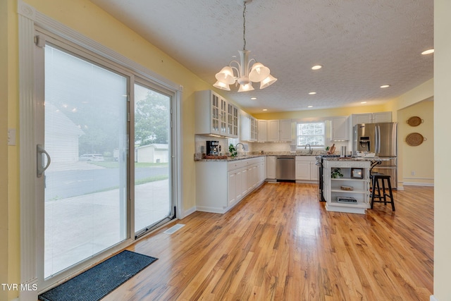 516 Bowmantown Rd, Telford, TN 37690 - kitchen featuring stainless steel appliances, open shelves, a chandelier, light wood finished floors, and recessed lighting