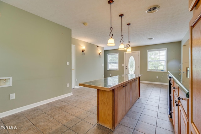 516 Bowmantown Rd, Telford, TN 37690 - kitchen featuring a kitchen island, light tile patterned flooring, baseboards, and tile countertops